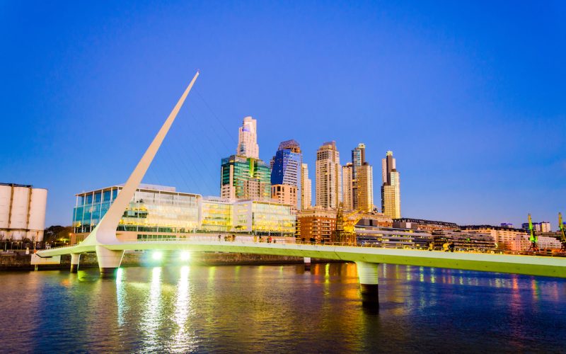 Women's Bridge and upscale skyscrapers at night in Puerto Madero neighborhood of Buenos Aires