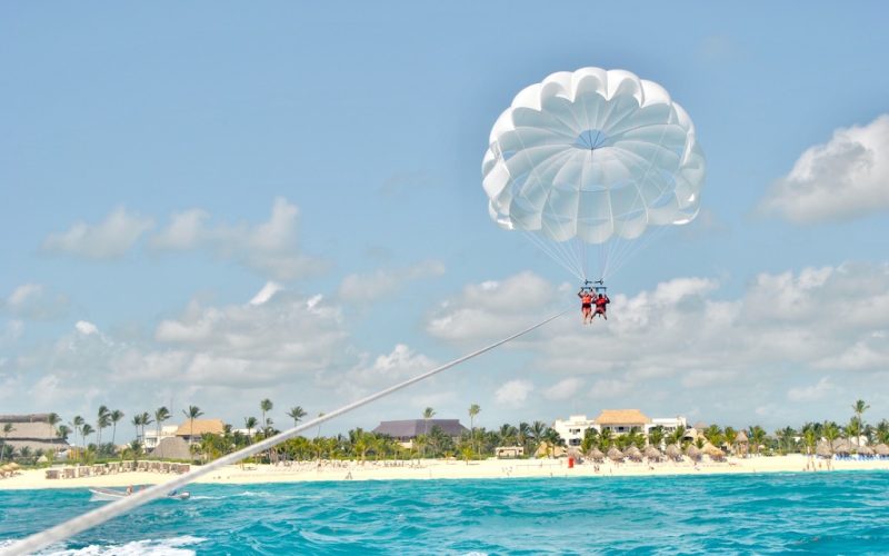 couple-parasailing-over-crystal-blue-water-in-domi-2022-11-02-18-16-50-utc