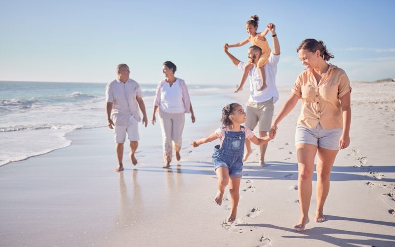 Family, beach and happy in cancun vacation in summer with smile, laugh and love together walking on.