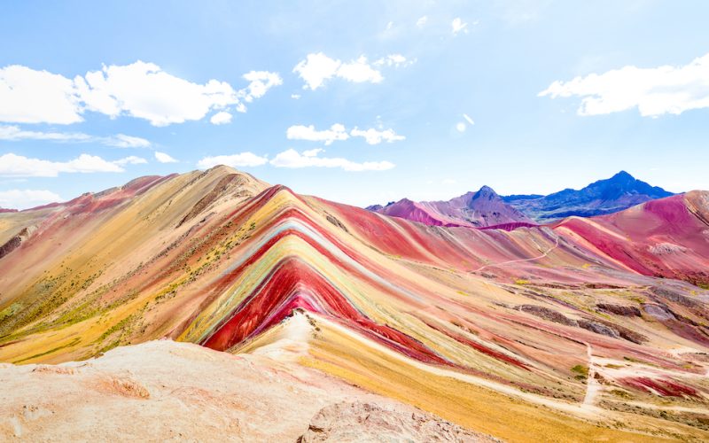 Panoramic view of Rainbow Mountain at Vinicunca mount in Peru - Travel and wanderlust concept exploring world nature wonders - Vivid multicolor filter with bright enhanced color tones